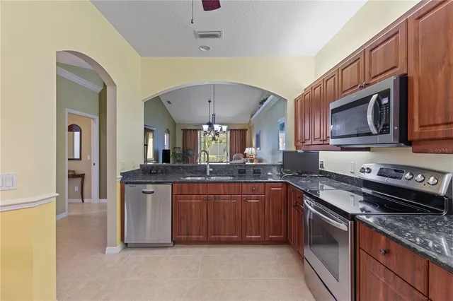 a kitchen with stainless steel appliances granite countertop a sink and stove top oven