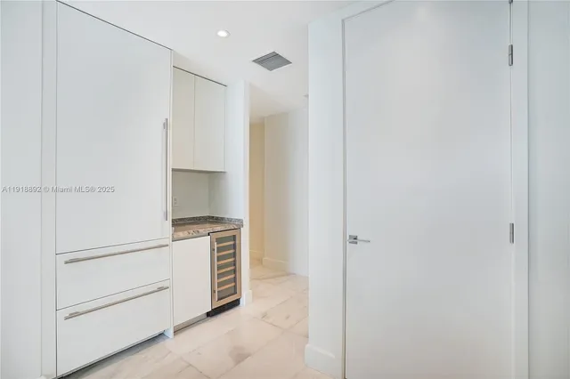 a view of a kitchen with white cabinets