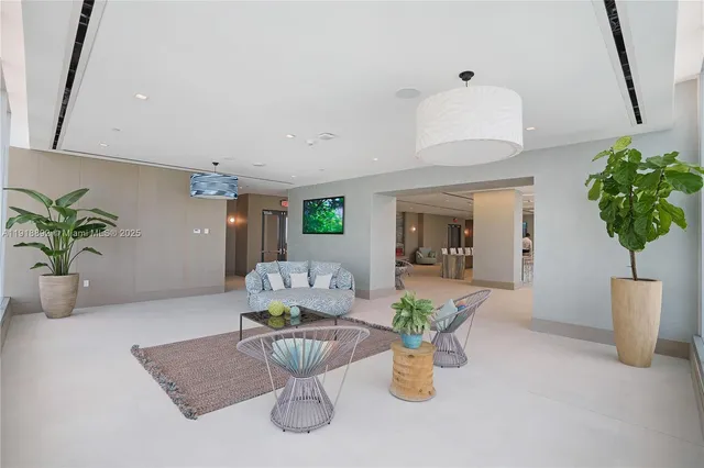 a view of a room with gym equipment and floor to ceiling window