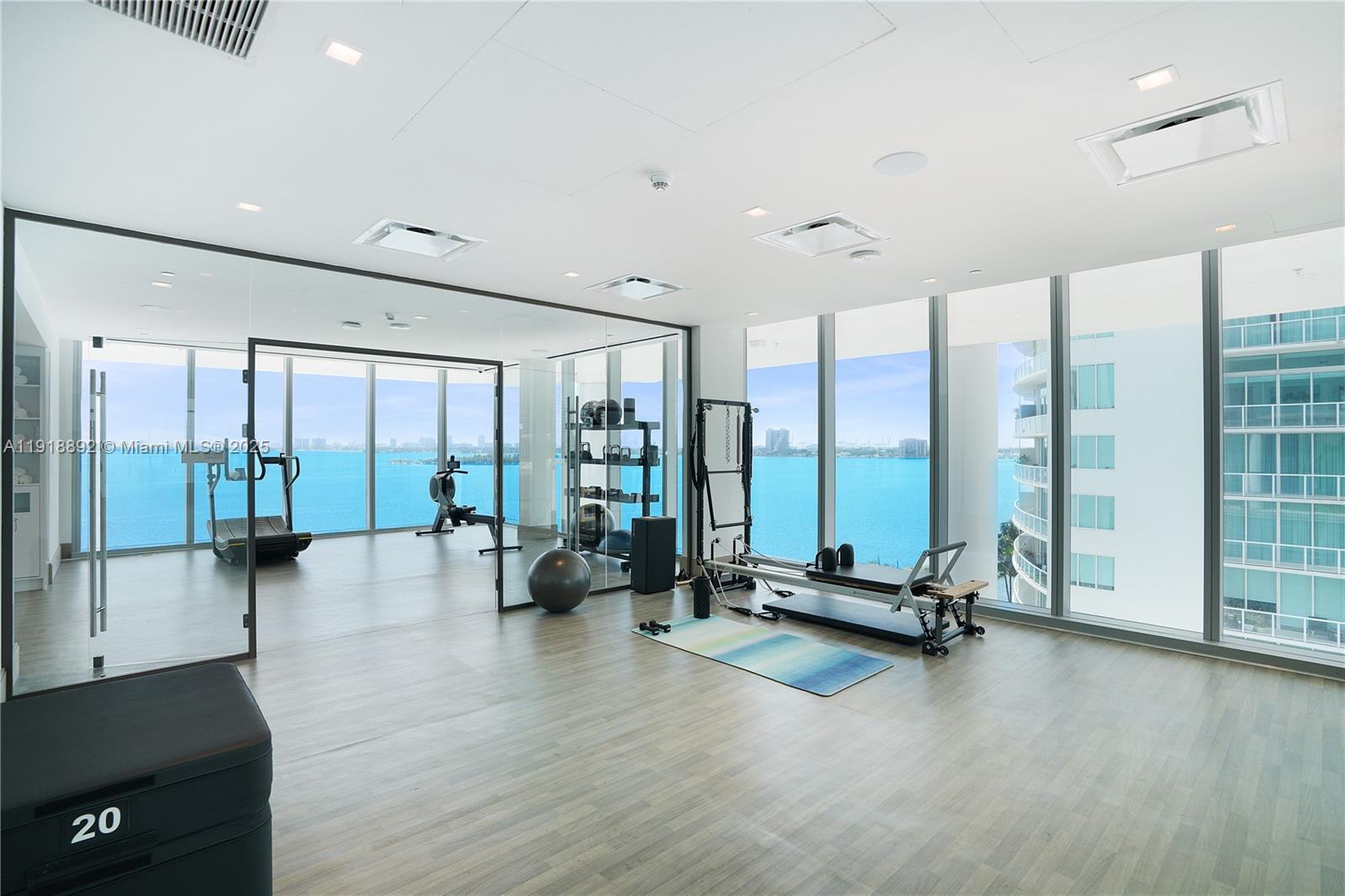 700 Northeast 26th Terrace, Unit 3604 Miami, FL 33137 - Photo 25 of 35 a view of a room with gym equipment and floor to ceiling window