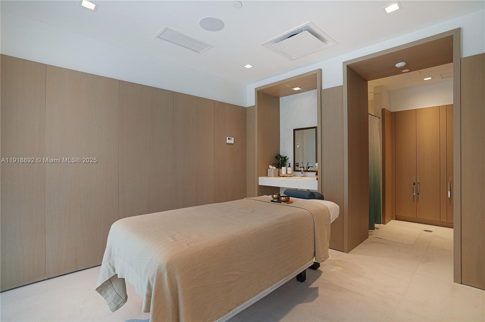 700 Northeast 26th Terrace, Unit 3604 Miami, FL 33137 - Photo 30 of 35 a bedroom with a bed and a mirror