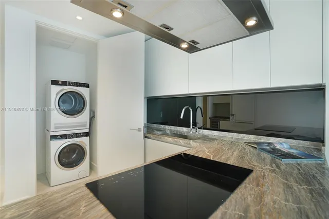 a kitchen with stainless steel appliances a stove a refrigerator and a microwave
