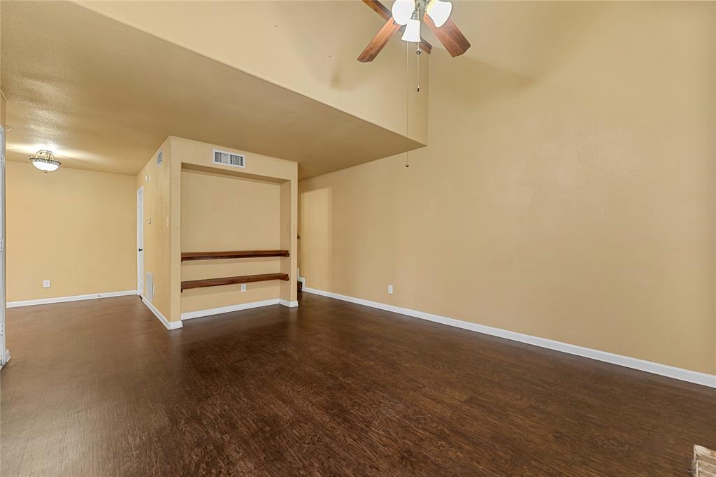 5516 Boca Raton Boulevard, Unit 310 Fort Worth, TX 76112 - Photo 12 of 19 a view of an empty room with a chandelier fan