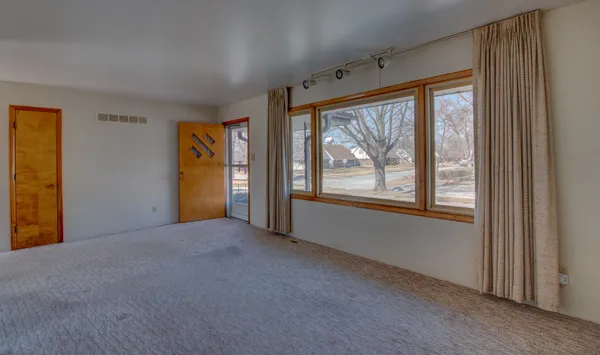 a view of an empty room with a window