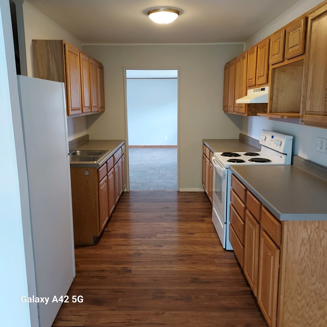508 East North Line Road Tuscola, IL 61953 - Photo 4 of 12 a kitchen with stainless steel appliances granite countertop a refrigerator a stove a sink and a microwave