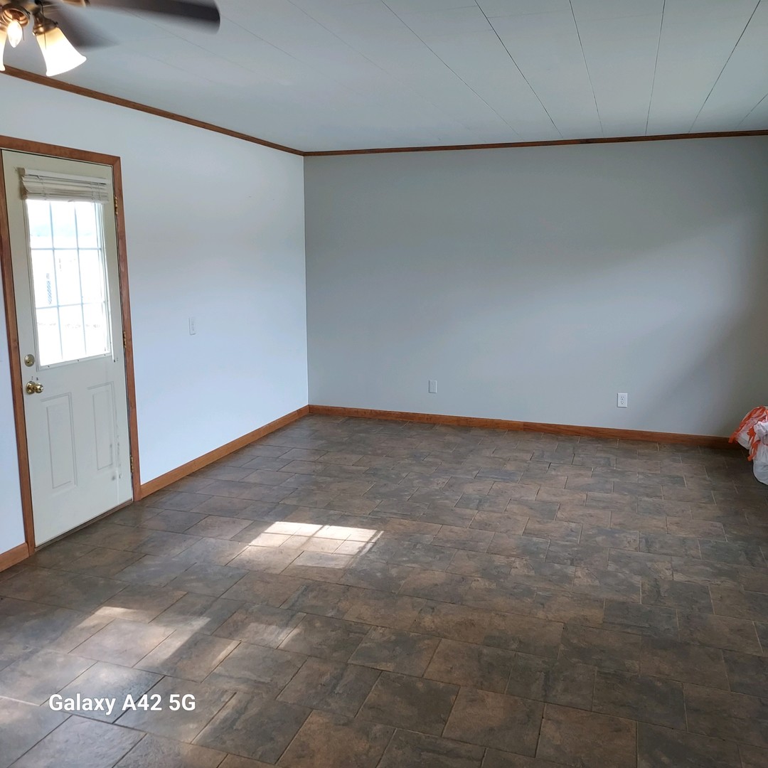 508 East North Line Road Tuscola, IL 61953 - Photo 6 of 12 an empty room with a workbench