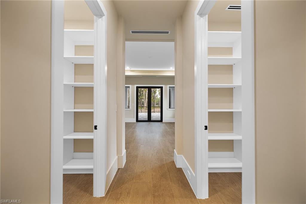 538 13th Street Southwest Naples, FL 34117 - Photo 12 of 25 a view of a hallway with wooden floor and closet