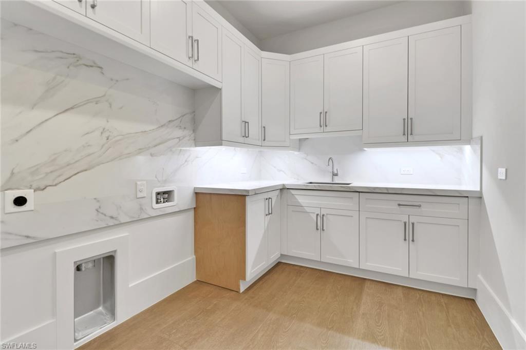538 13th Street Southwest Naples, FL 34117 - Photo 19 of 25 a kitchen with granite countertop white cabinets and white appliances