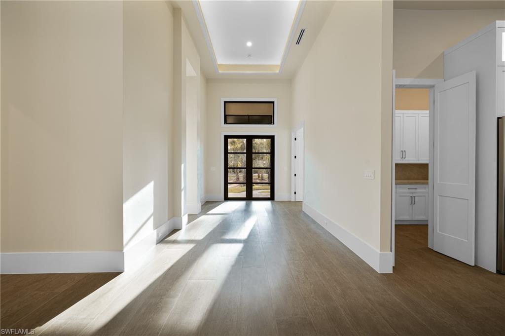 538 13th Street Southwest Naples, FL 34117 - Photo 3 of 25 wooden floor in an empty room with a window