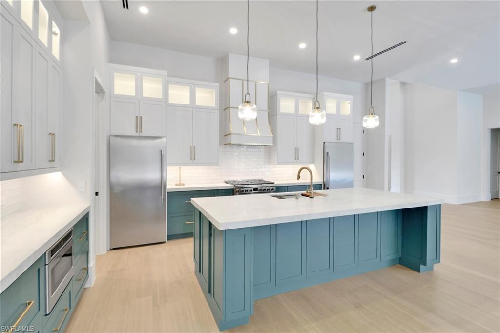 538 13th Street Southwest Naples, FL 34117 - Photo 5 of 25 a kitchen with kitchen island a sink stove and refrigerator