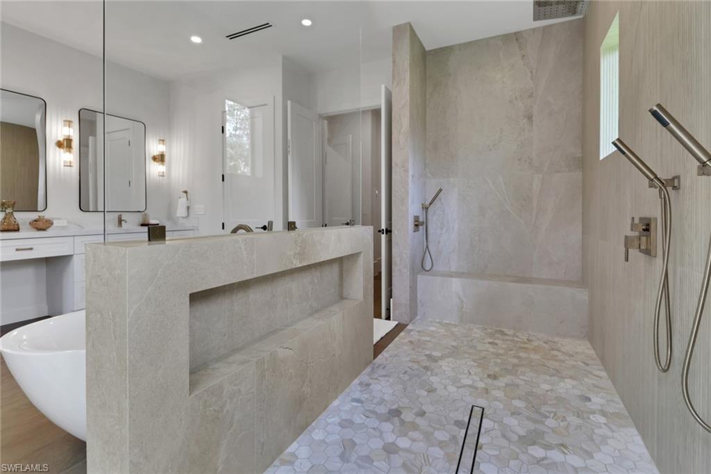538 13th Street Southwest Naples, FL 34117 - Photo 5 of 15 a bathroom with a double vanity sink a large mirror and shower