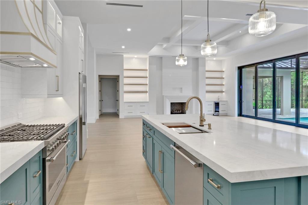 538 13th Street Southwest Naples, FL 34117 - Photo 6 of 25 a kitchen with stainless steel appliances granite countertop a sink stove and refrigerator