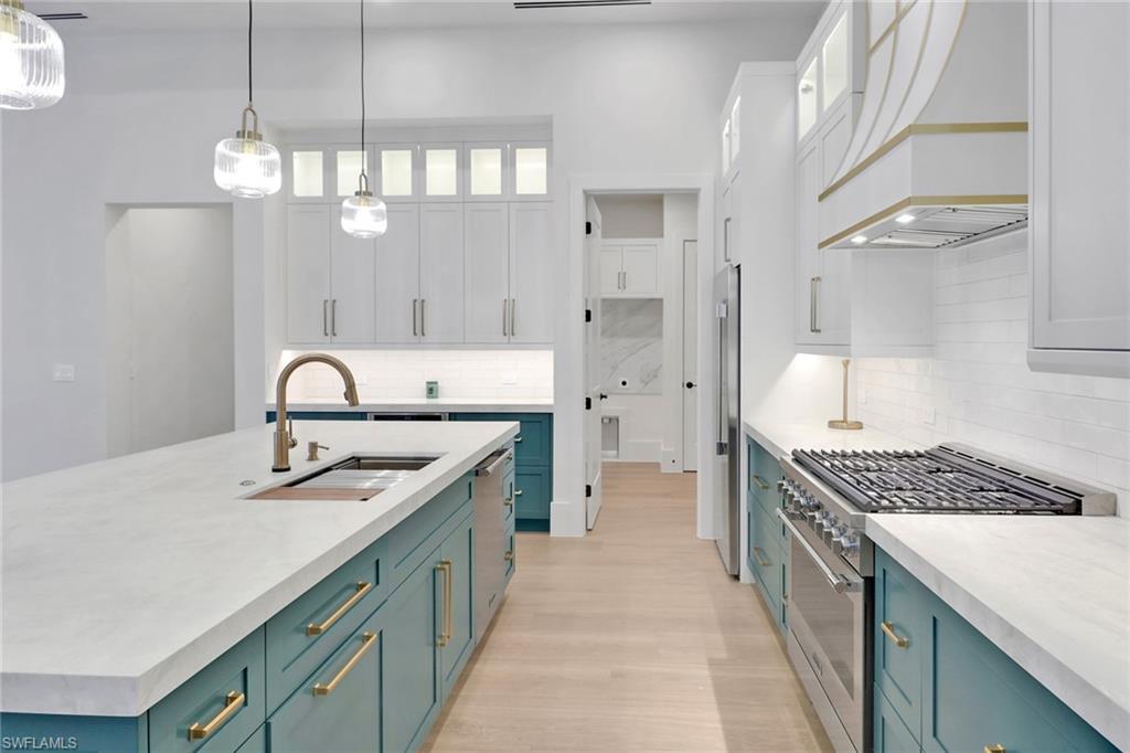 538 13th Street Southwest Naples, FL 34117 - Photo 7 of 25 a kitchen with a sink stove and cabinets
