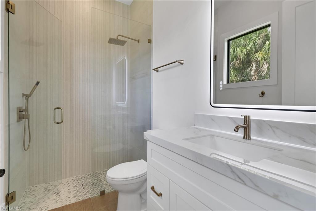538 13th Street Southwest Naples, FL 34117 - Photo 8 of 15 a bathroom with a toilet sink and shower