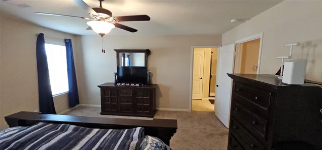 a view of a hallway to a livingroom with furniture