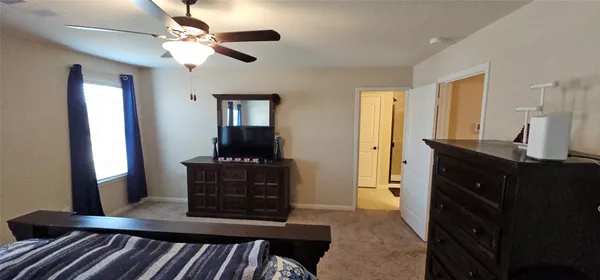 a bedroom with a bed and a dresser