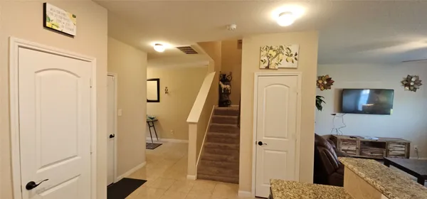 a view of a kitchen with furniture and a refrigerator