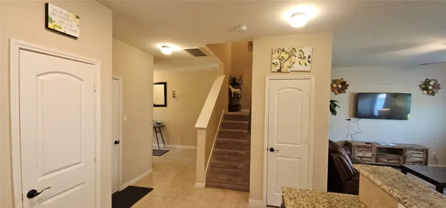 a view of a kitchen with furniture and a refrigerator