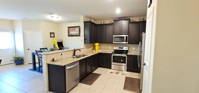 a kitchen with a sink stove and refrigerator