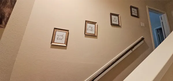 a view of a hallway with paintings on the wall