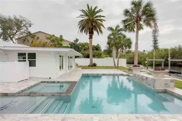a view of a swimming pool with a yard