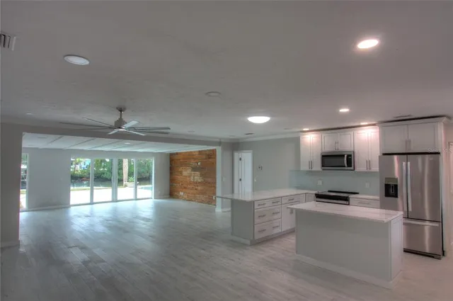 a kitchen with stainless steel appliances a refrigerator and a stove top oven