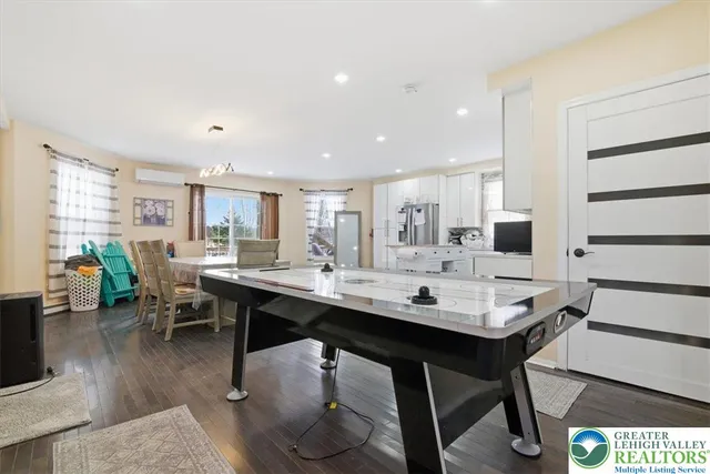 a kitchen with stainless steel appliances granite countertop a refrigerator a sink and white cabinets