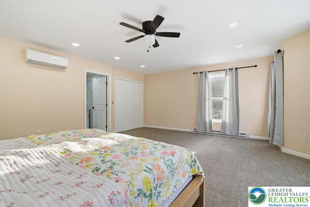 a bedroom with a bed and a night stand