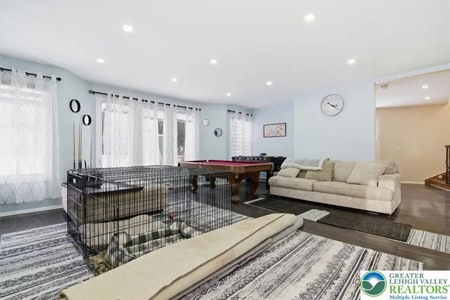 a view of a kitchen area with furniture and wooden floor