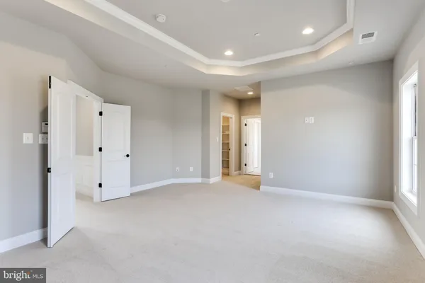 an empty room with closet and a window