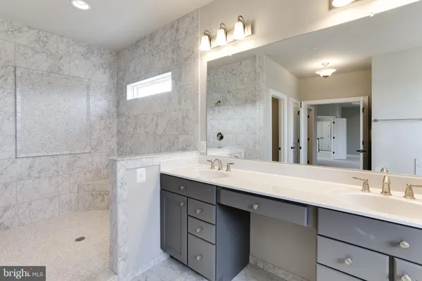 a bathroom with a sink double vanity and a mirror