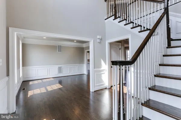 a view of entryway with wooden floor and stair