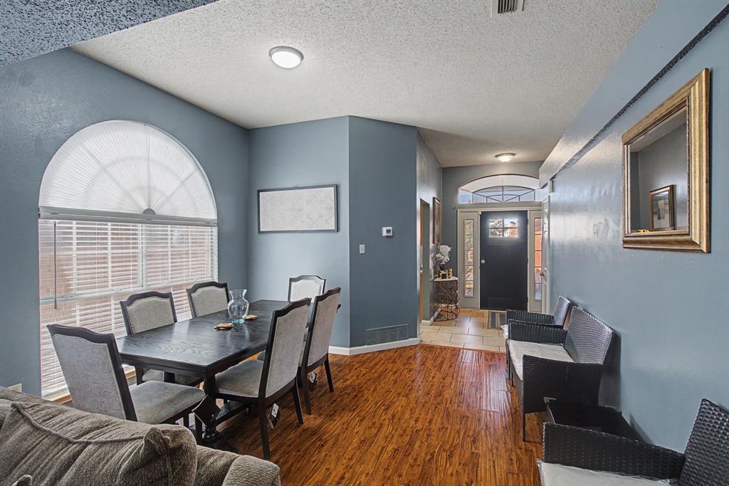 645 Cross Ridge Circle Fort Worth, TX 76120 - Photo 13 of 26 Dining area with wood finished floors and a textured ceiling