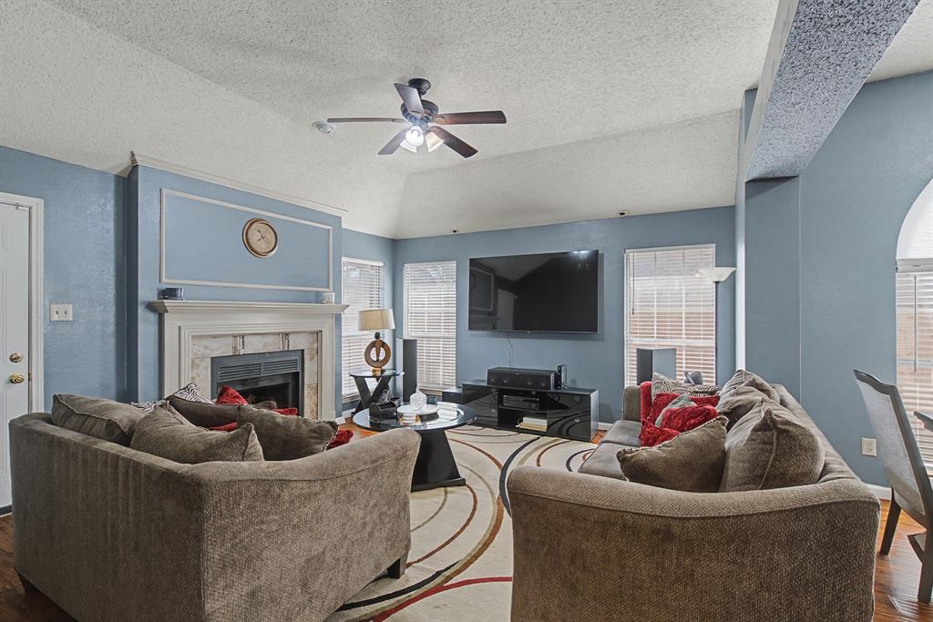 645 Cross Ridge Circle Fort Worth, TX 76120 - Photo 14 of 26 Living room featuring hardwood / wood-style floors, a fireplace, and a ceiling fan