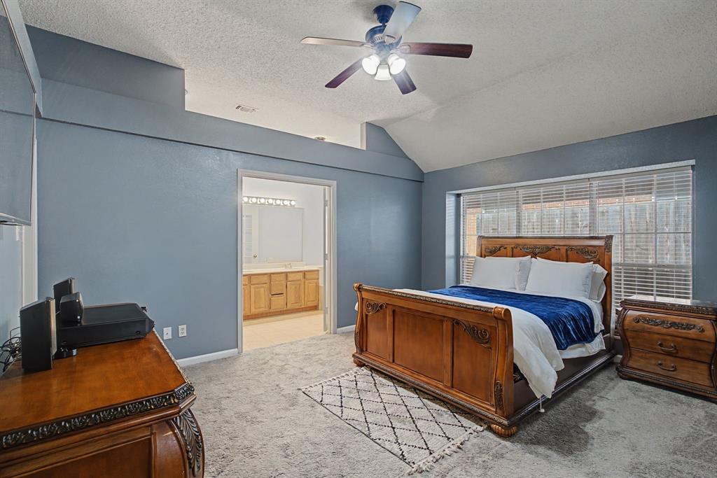 645 Cross Ridge Circle Fort Worth, TX 76120 - Photo 18 of 26 Primary Bedroom with light colored carpet, a ceiling fan, and ensuite bathroom