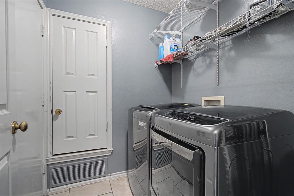 645 Cross Ridge Circle Fort Worth, TX 76120 - Photo 23 of 26 Laundry area featuring light tile patterned flooring, room for full size washer and clothes dryer.