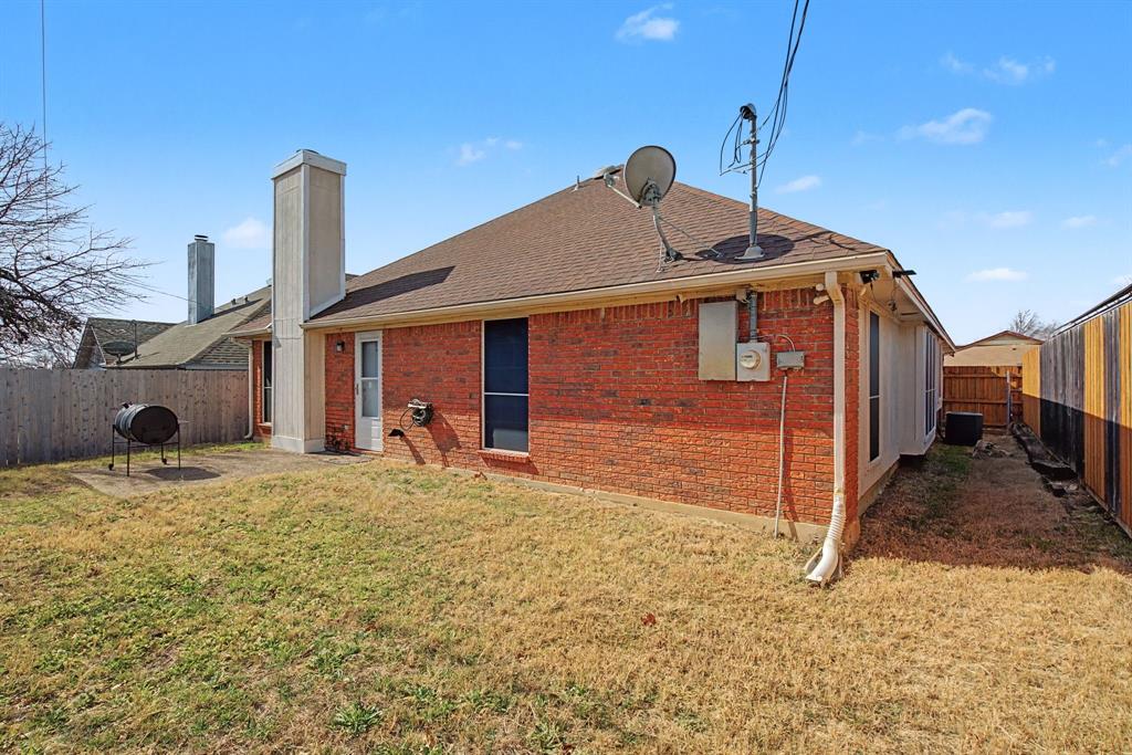 645 Cross Ridge Circle Fort Worth, TX 76120 - Photo 25 of 26 Rear view of property featuring a fenced backyard, brick siding, a chimney, and roof with shingles