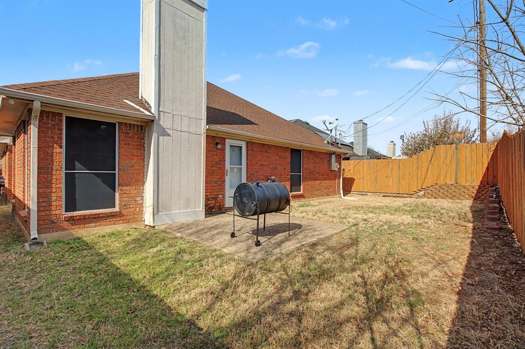 645 Cross Ridge Circle Fort Worth, TX 76120 - Photo 26 of 26 Rear view of property with a chimney, a shingled roof, brick siding, and a fenced backyard