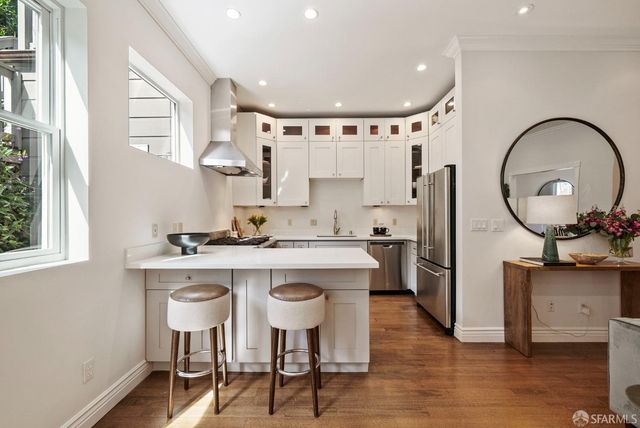 a kitchen with cabinets and appliances