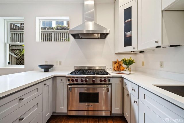 a view of a patio with couches table and chairs and potted plants