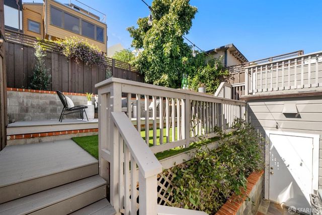a view of a house with backyard and deck