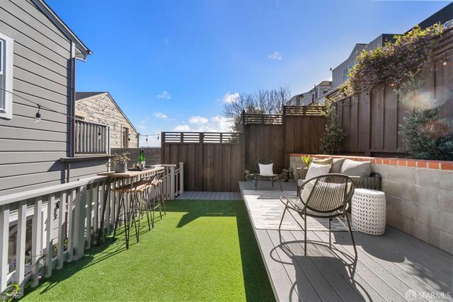 a view of a house with backyard and sitting area