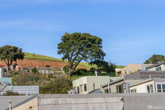 a living room with furniture a large window and wooden floor