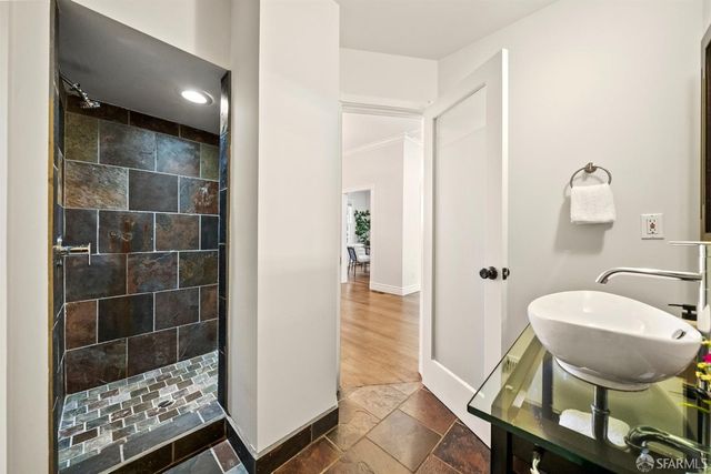 a view of a chair and tables in the balcony