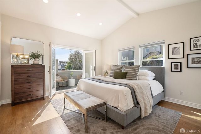 a bed room with a bed and a potted plant