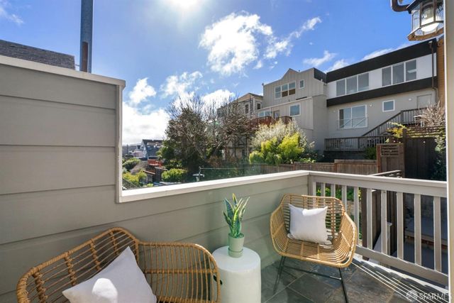 a bedroom with a bed and painting on the wall