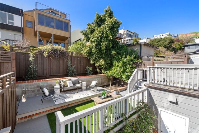a bathroom with a granite countertop toilet a sink a mirror a vanity and shower