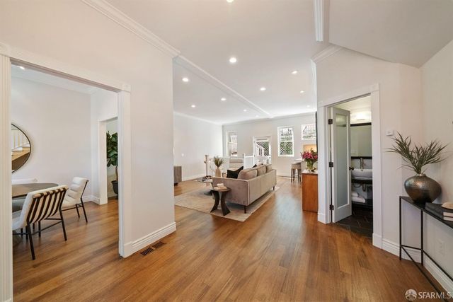 a dining room with furniture a window and wooden floor