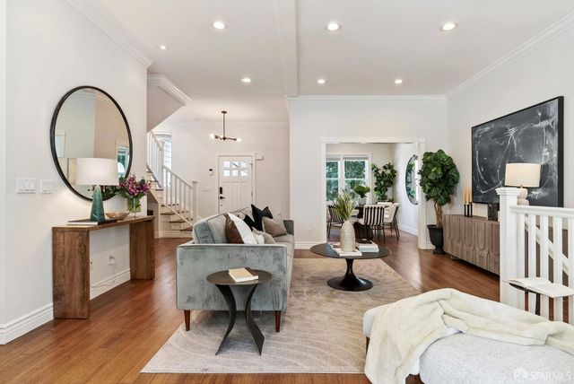 a kitchen with cabinets a sink appliances and a dining table
