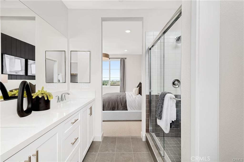 242 Solaro Court Walnut, CA 91789 - Photo 11 of 15 a bathroom with a double vanity sink a mirror and shower